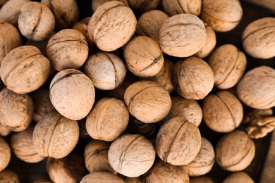 Photo of Many tasty walnuts as background, top view