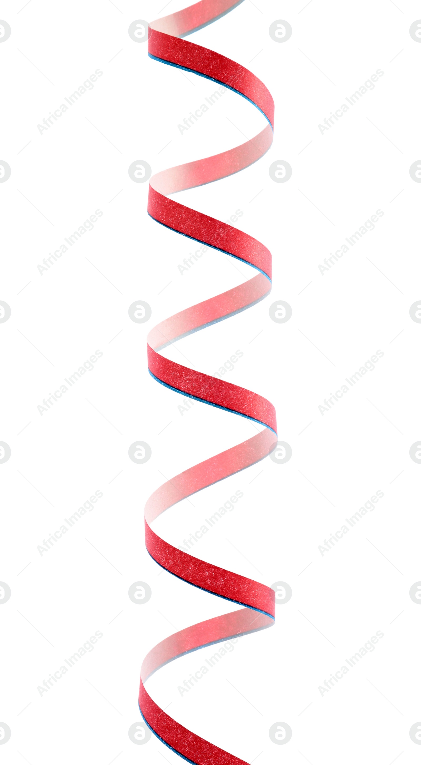 Photo of Bright serpentine streamer on white background. Festive decor