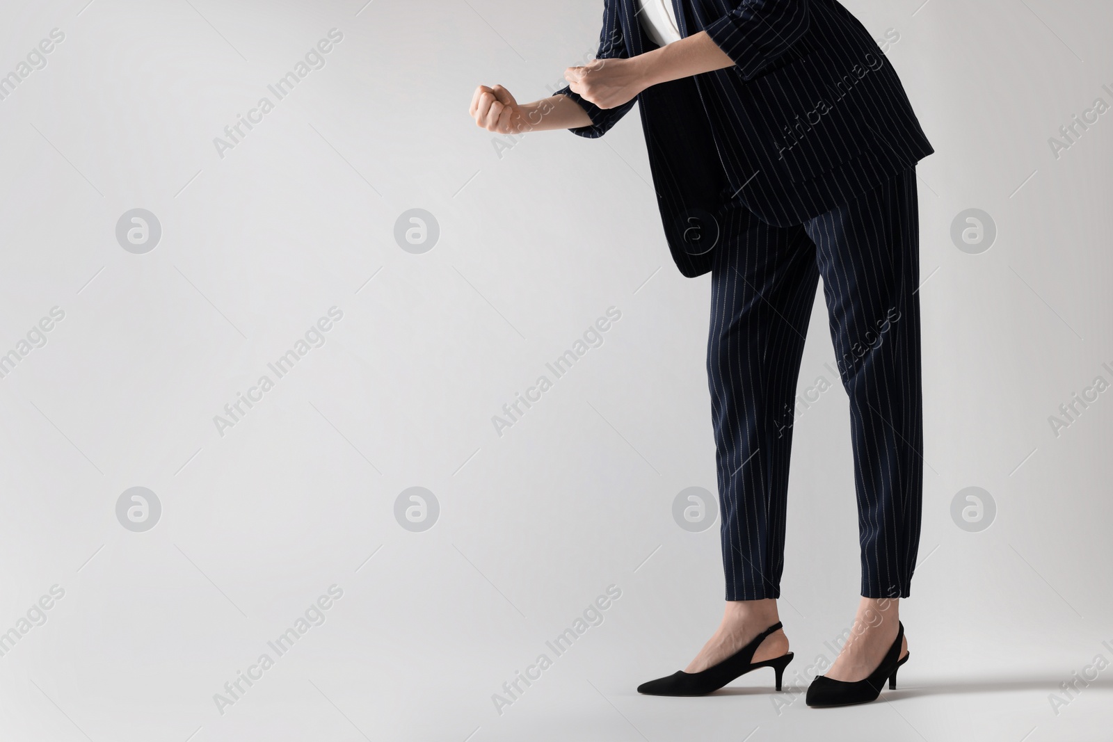 Photo of Businesswoman with angry fists on white background, closeup