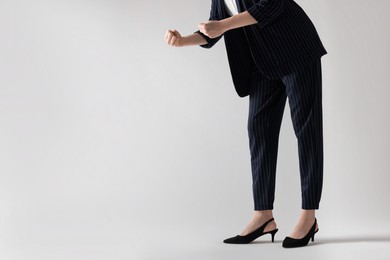 Businesswoman with angry fists on white background, closeup