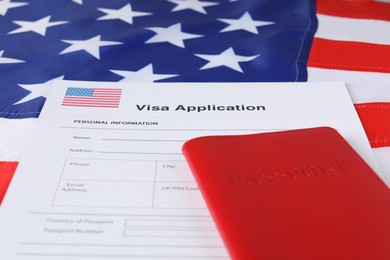 Photo of Immigration to USA. Visa application form and passport on flag, closeup
