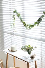 Photo of Stylish room decorated with beautiful eucalyptus garland