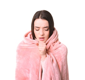 Young woman with cold wrapped in blanket on white background