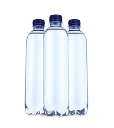 Photo of Plastic bottles with water on table against white background
