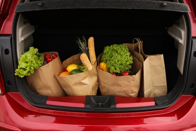 Photo of Bags full of groceries in car trunk, closeup view
