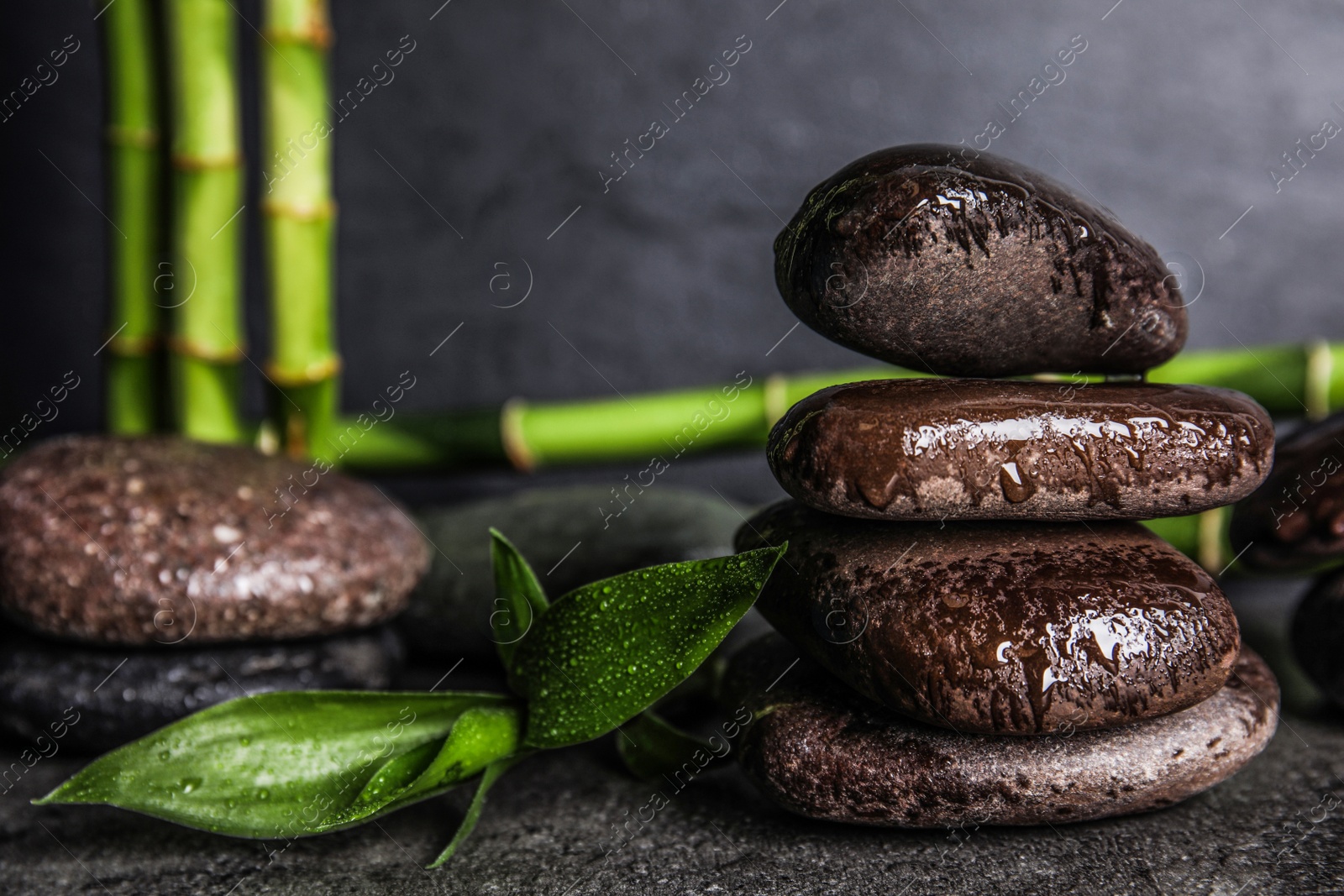 Photo of Composition with stones and bamboo on table. Zen concept