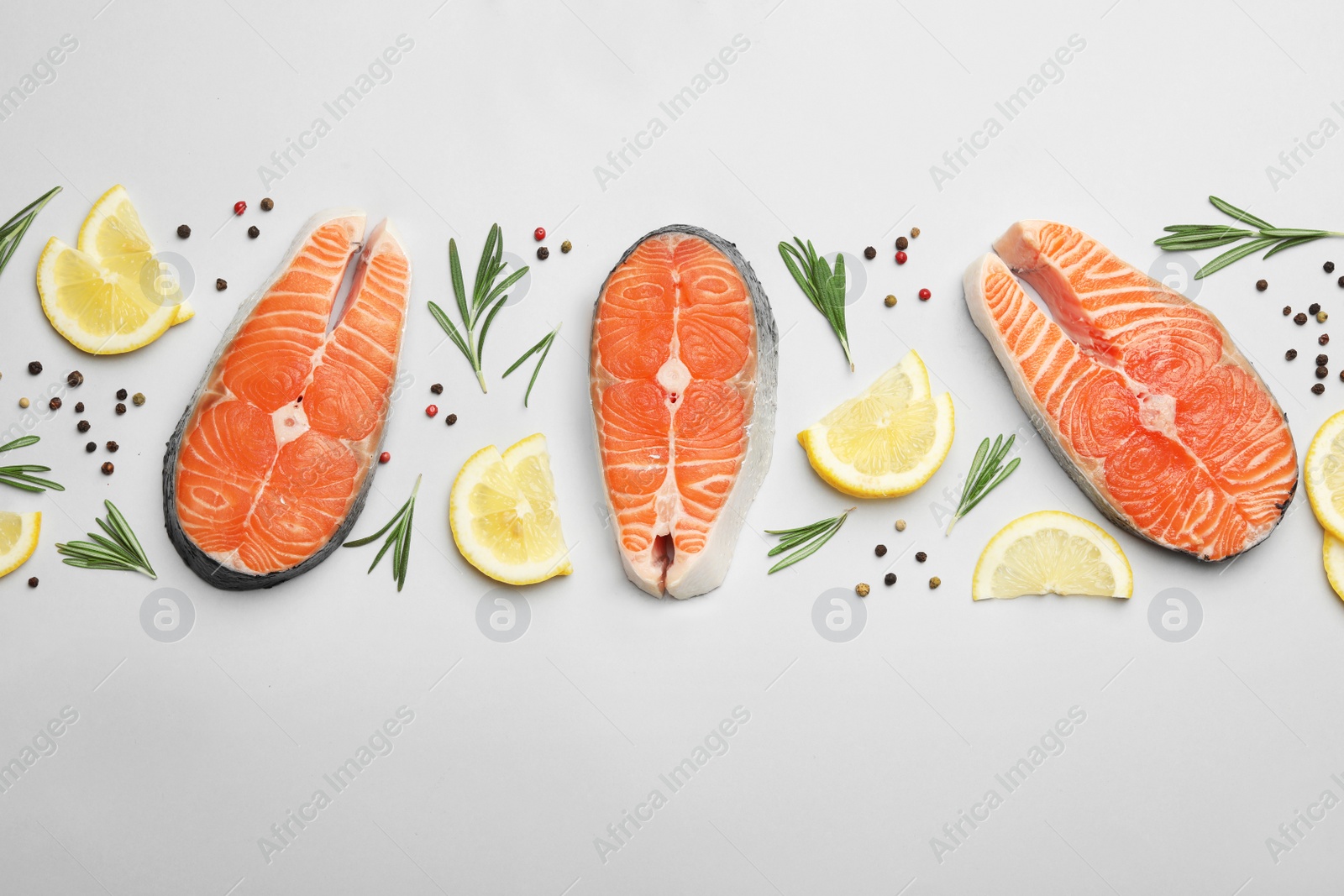 Photo of Flat lay composition with salmon steaks white background