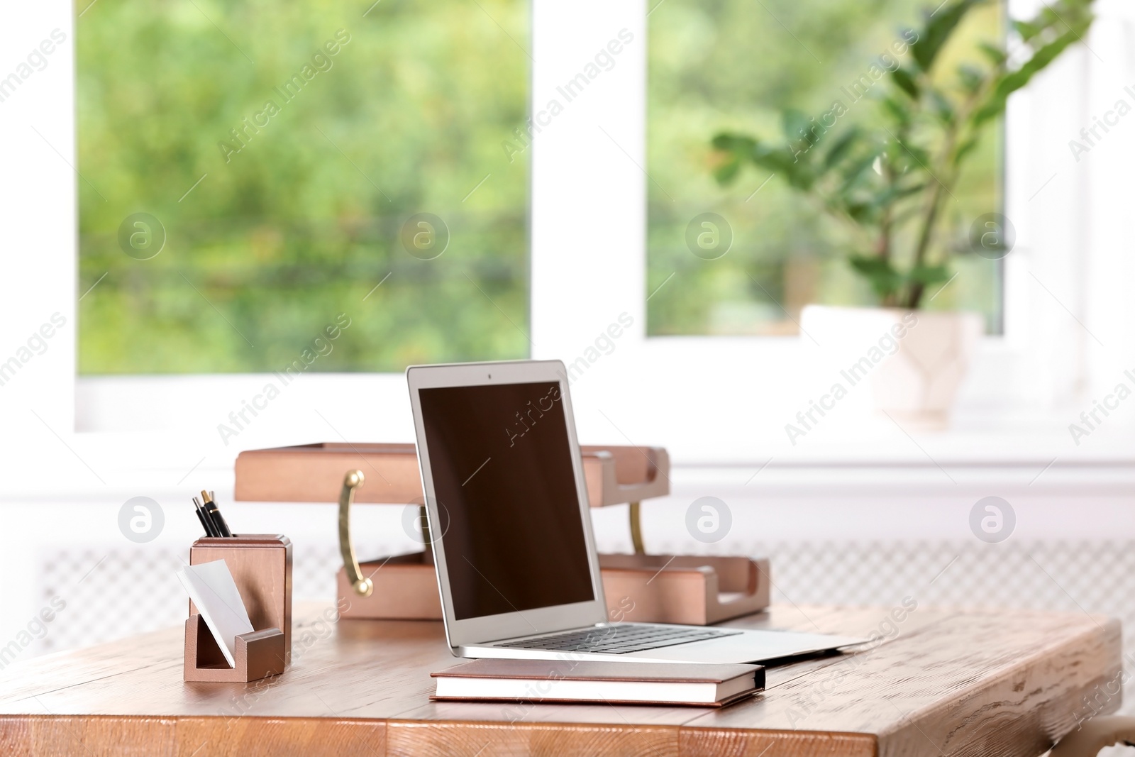 Photo of Table with laptop and stationery in lawyer's office