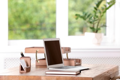 Photo of Table with laptop and stationery in lawyer's office