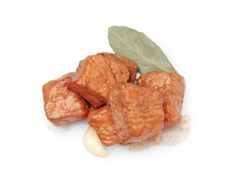 Photo of Pieces of delicious cooked beef, garlic and bay leaf isolated on white, top view. Tasty goulash