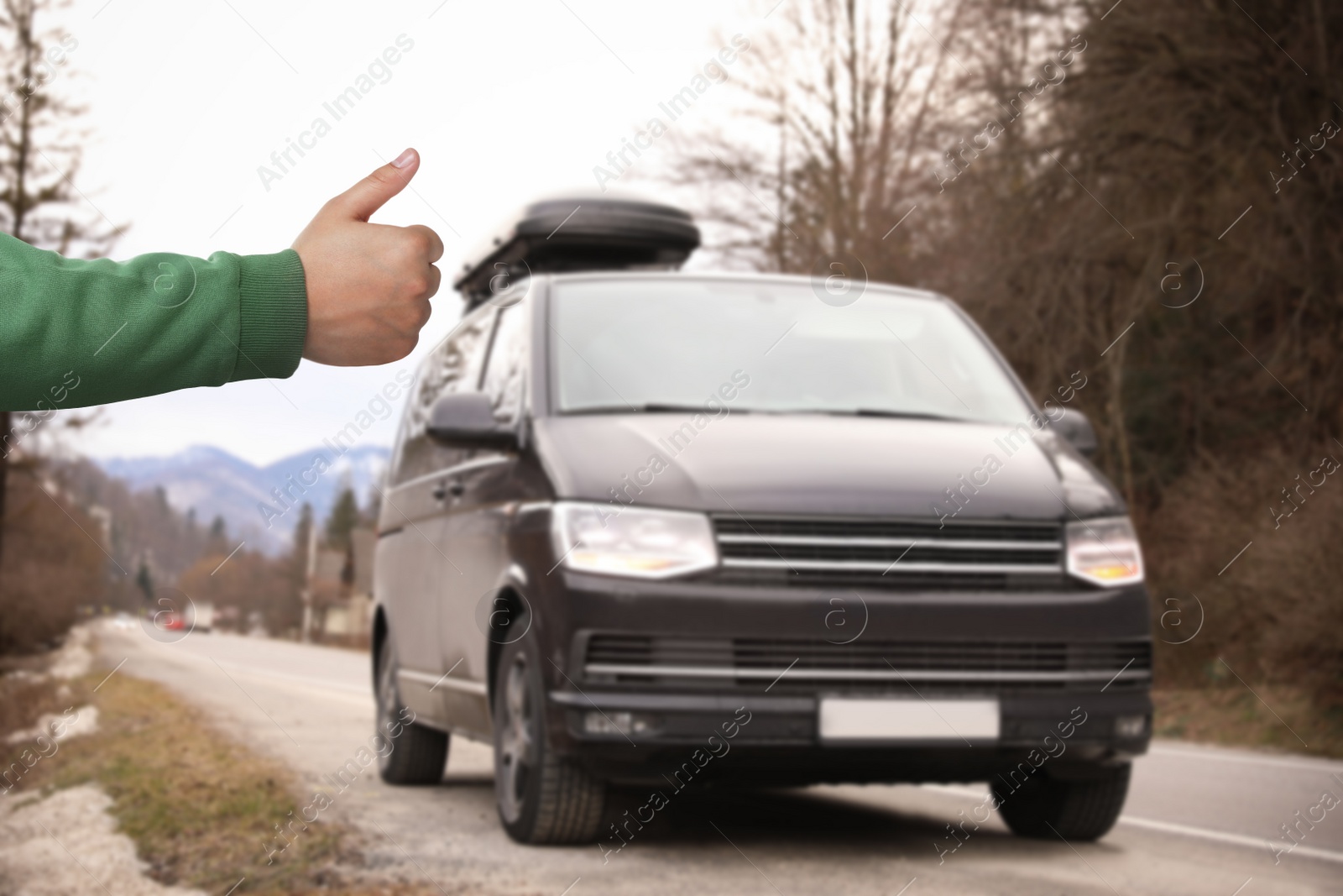 Image of Man catching car on road, closeup. Hitchhiking trip