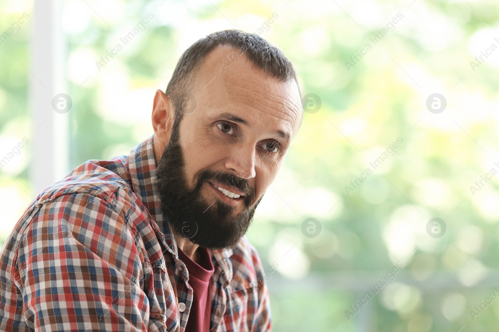 Photo of Portrait of handsome mature man on blurred background