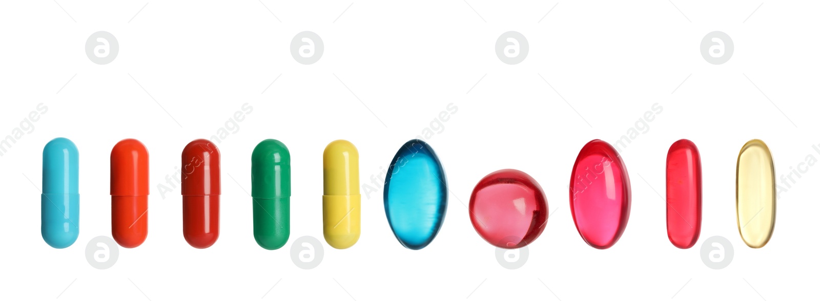 Image of Set of different color pills in row isolated on white