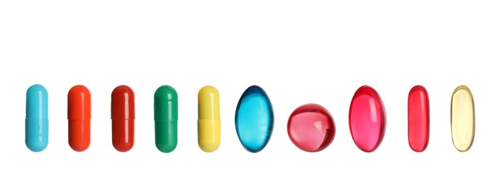 Image of Set of different color pills in row isolated on white