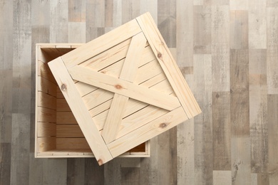 Photo of Wooden crate on floor, top view. Space for text