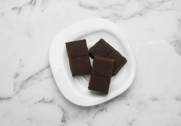 Photo of Plate with delicious and healthy hematogen on marble table, top view