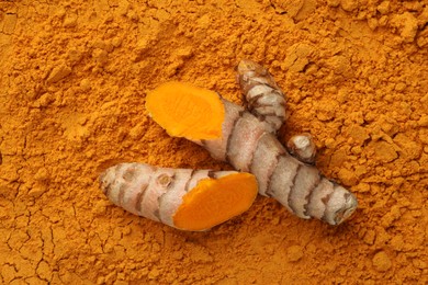 Cut raw root on aromatic turmeric powder, top view