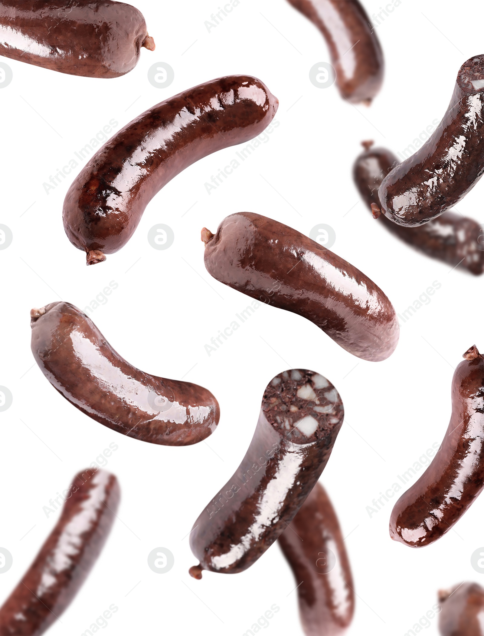 Image of Tasty blood sausages falling on white background 