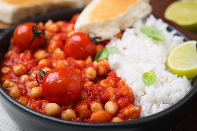 Photo of Delicious chickpea curry with rice in bowl, closeup