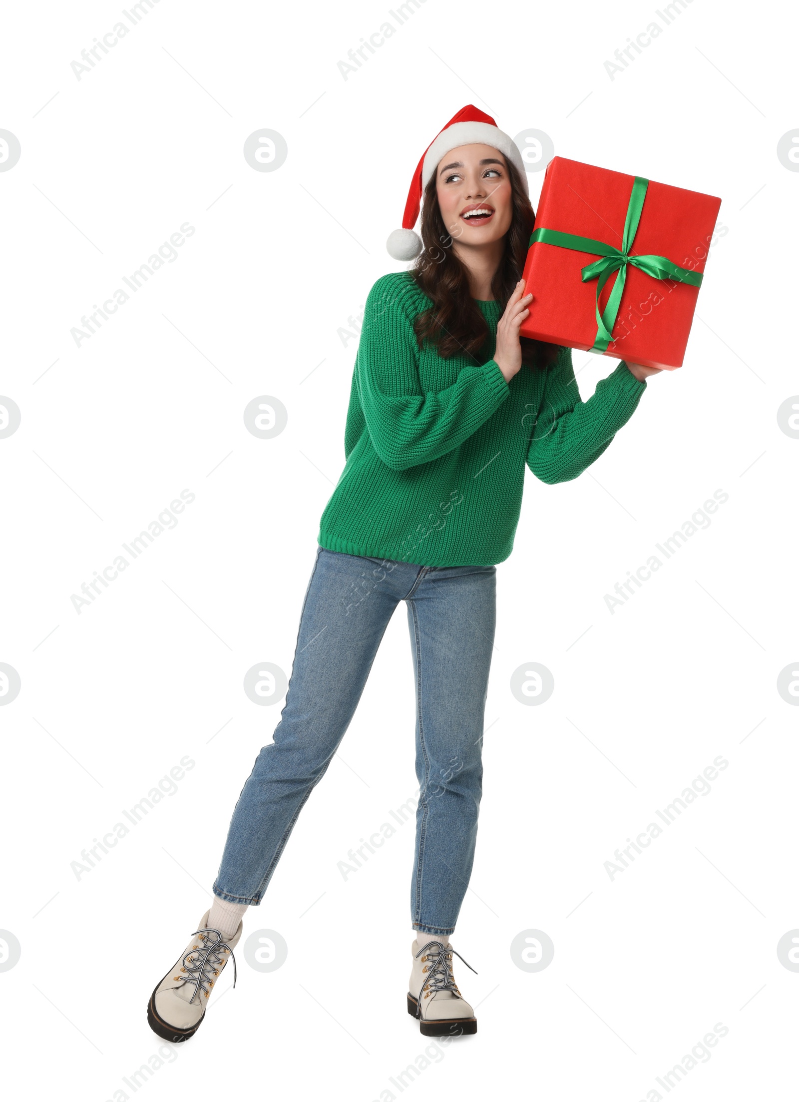 Photo of Beautiful young woman in Santa hat with Christmas celebration gift isolated on white