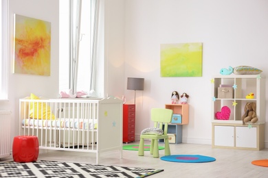 Photo of Baby room interior with comfortable crib