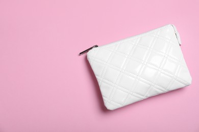 Photo of White leather cosmetic bag on pink background, top view. Space for text