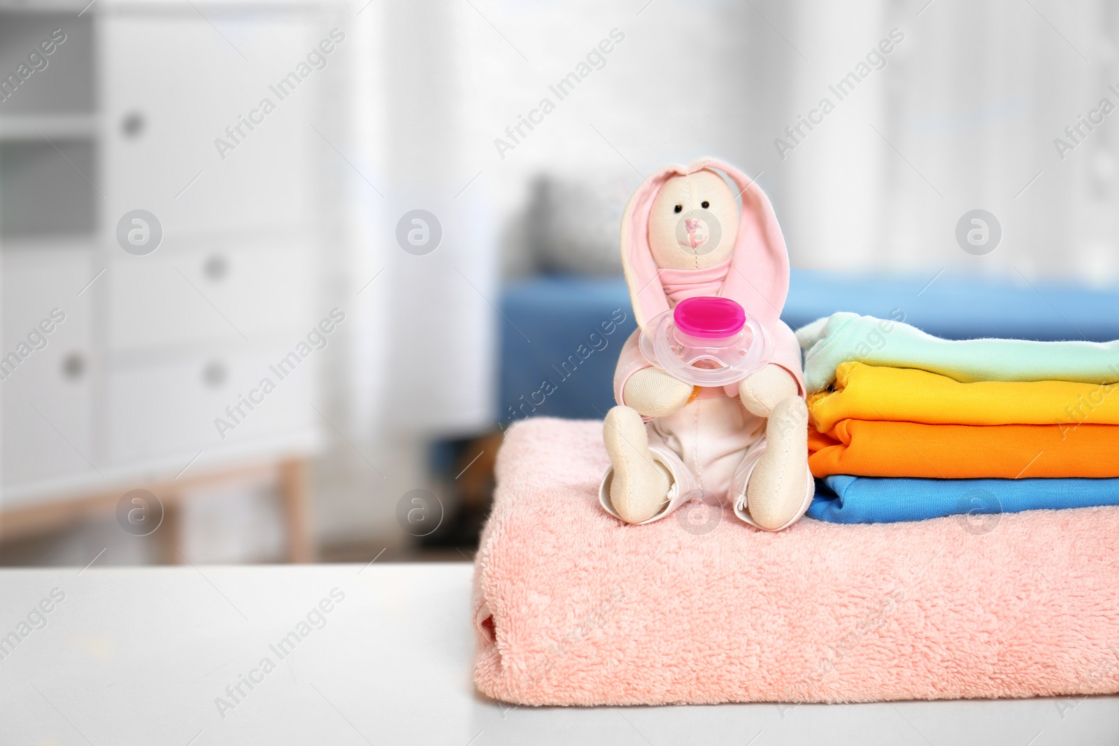 Photo of Baby accessories on table in nursery room. Space for text