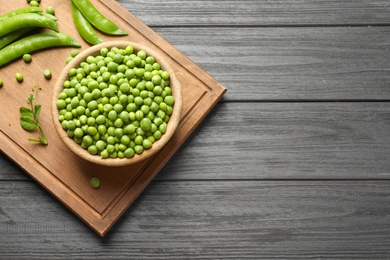 Photo of Flat lay composition with green peas on wooden background