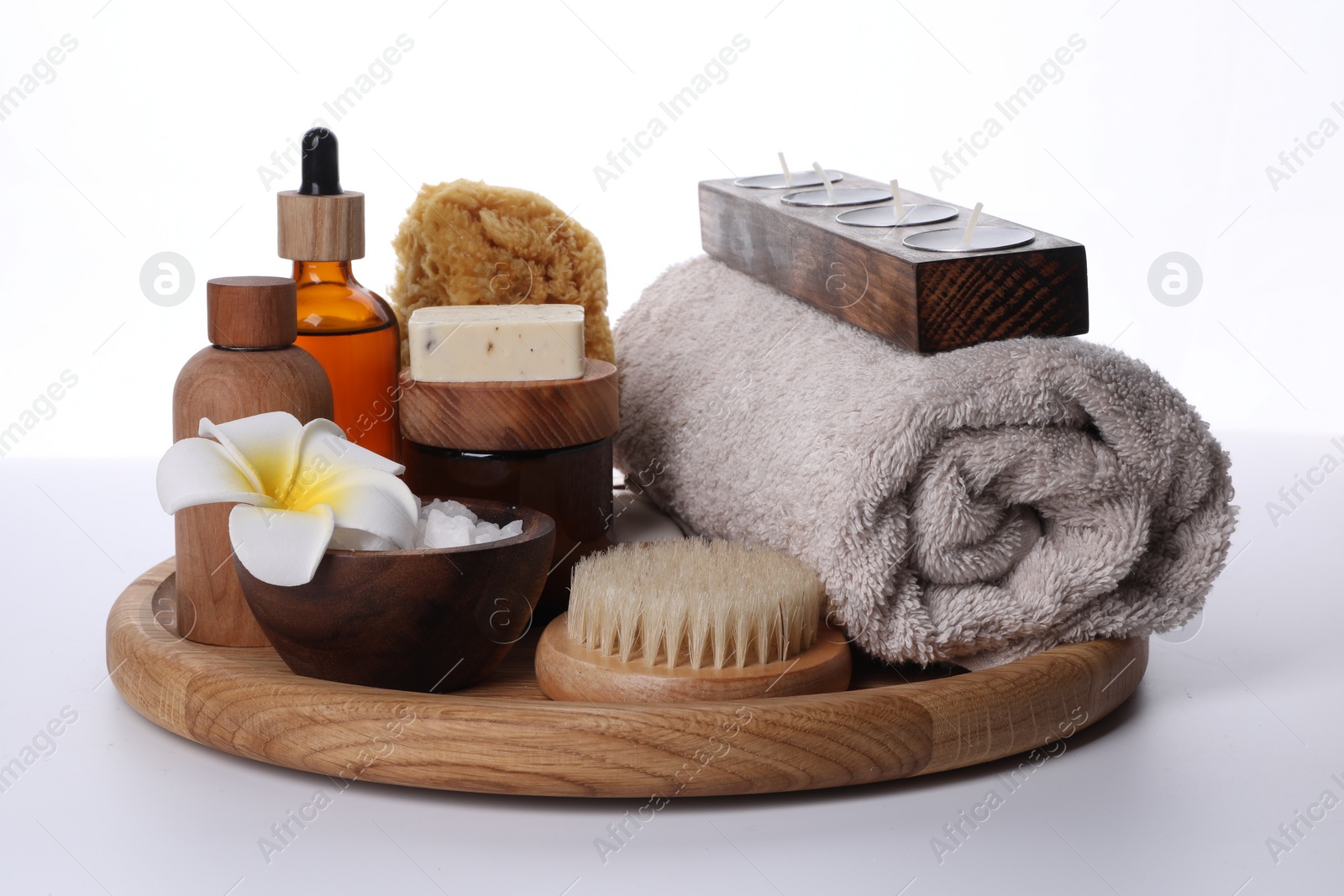 Photo of Composition with spa products, flower and candles isolated on white