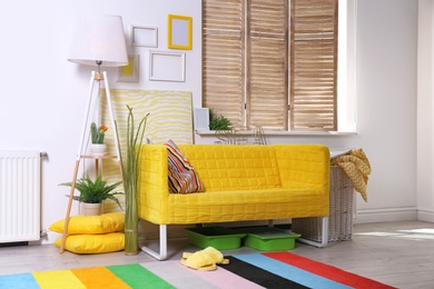 Elegant living room interior with comfortable sofa. Home design in rainbow colors