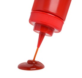 Photo of Pouring tasty red ketchup from bottle isolated on white