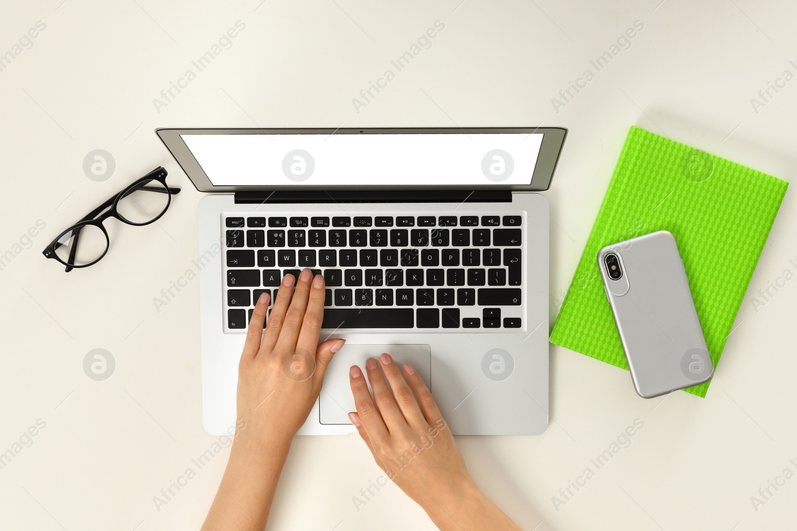 Photo of Woman using modern laptop on light background, top view