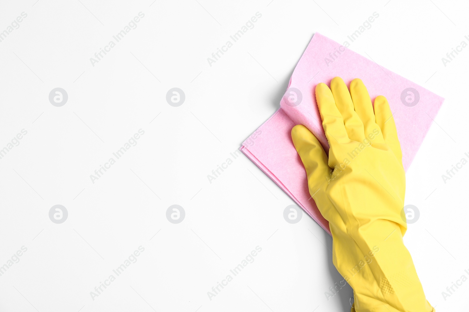 Photo of Person in rubber glove with rag on white background, closeup of hand