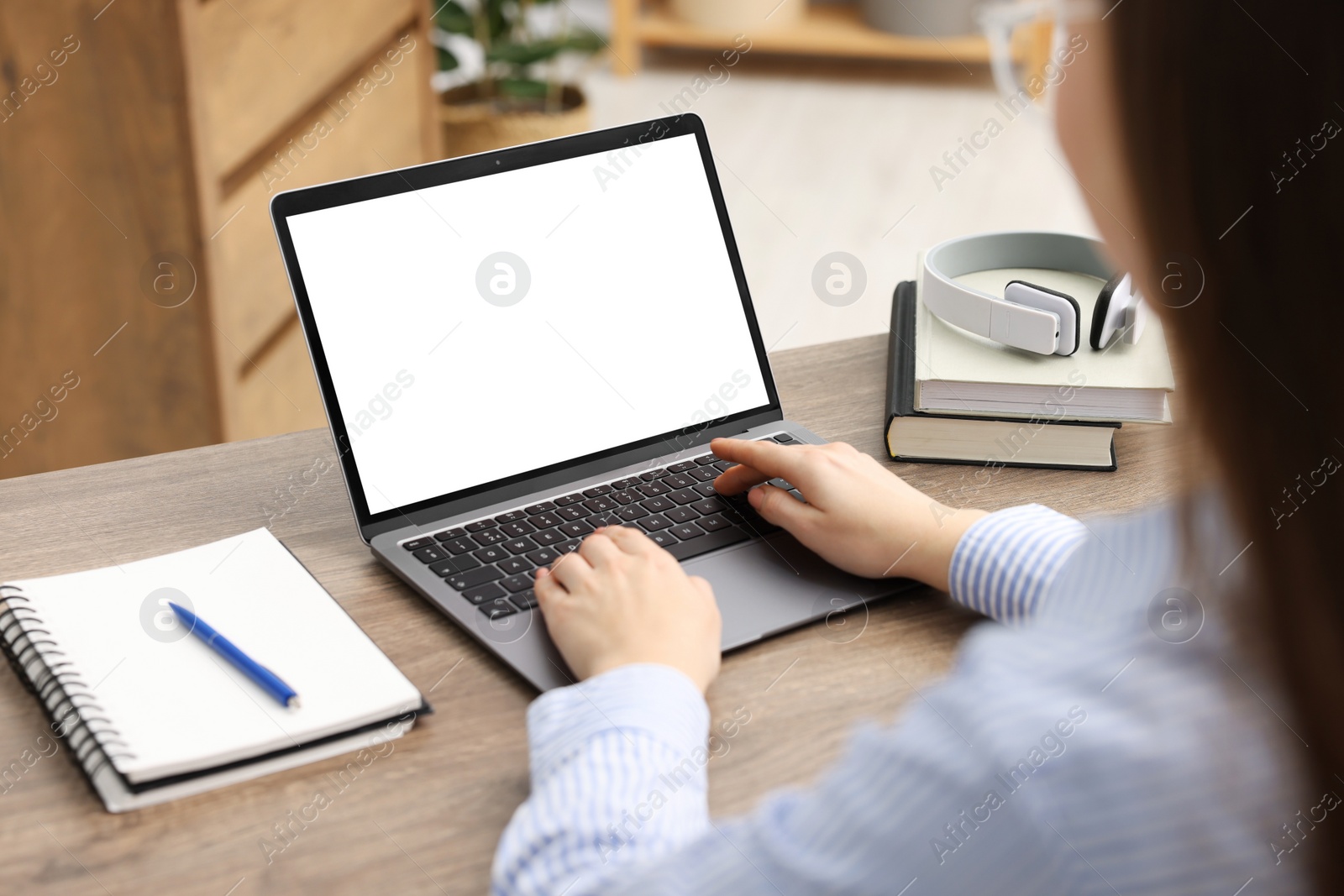 Photo of E-learning. Woman using laptop during online lesson indoors, closeup