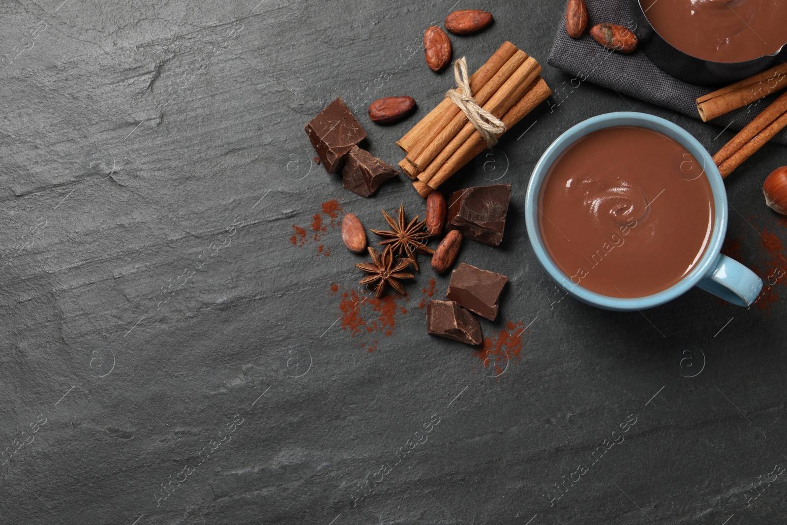 Photo of Flat lay composition with yummy hot chocolate on black table. Space for text