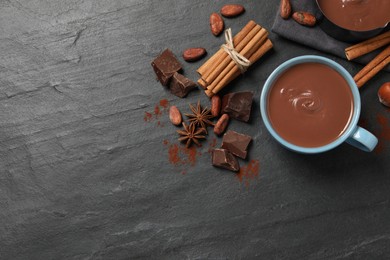 Photo of Flat lay composition with yummy hot chocolate on black table. Space for text