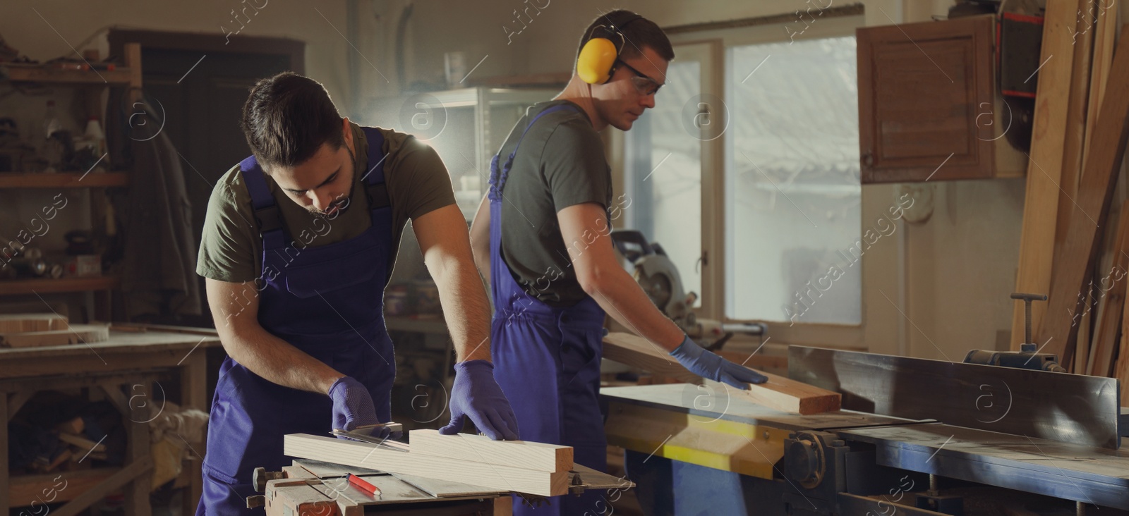 Image of Professional carpenters working with wood in shop. Banner design