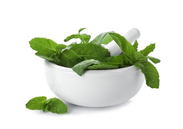 Photo of Mortar with fresh green herbs on white background