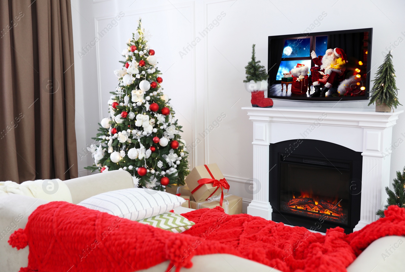 Image of Stylish living room interior with TV set, Christmas tree and fireplace