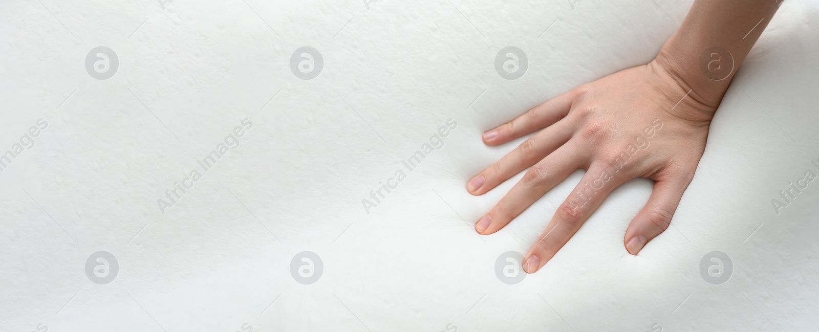 Image of Woman touching memory foam pillow, closeup. Banner design with space for text