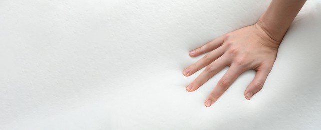 Image of Woman touching memory foam pillow, closeup. Banner design with space for text