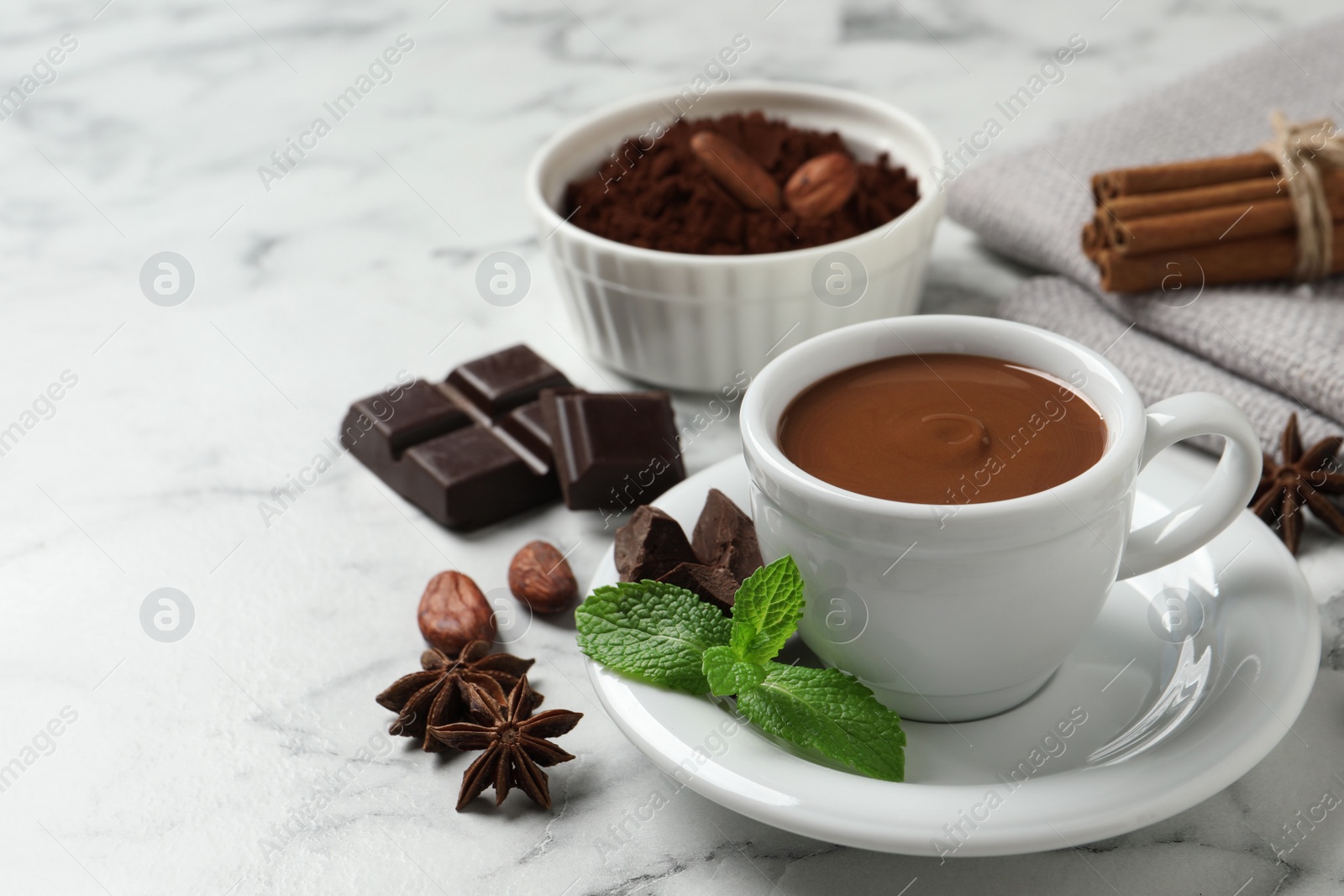 Photo of Composition with yummy hot chocolate in cup on white marble table, space for text