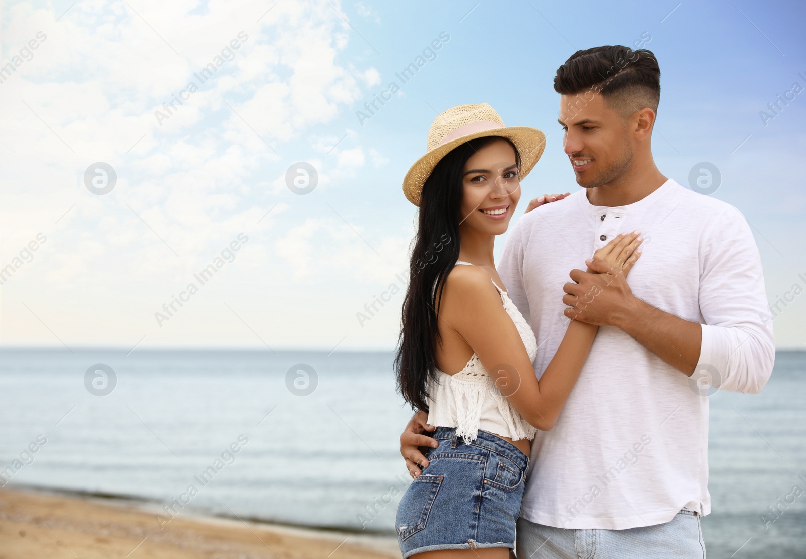 Photo of Lovely couple spending time together on beach. Space for text