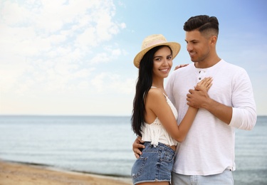 Lovely couple spending time together on beach. Space for text