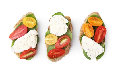 Photo of Delicious sandwiches with burrata cheese and tomatoes isolated on white, top view