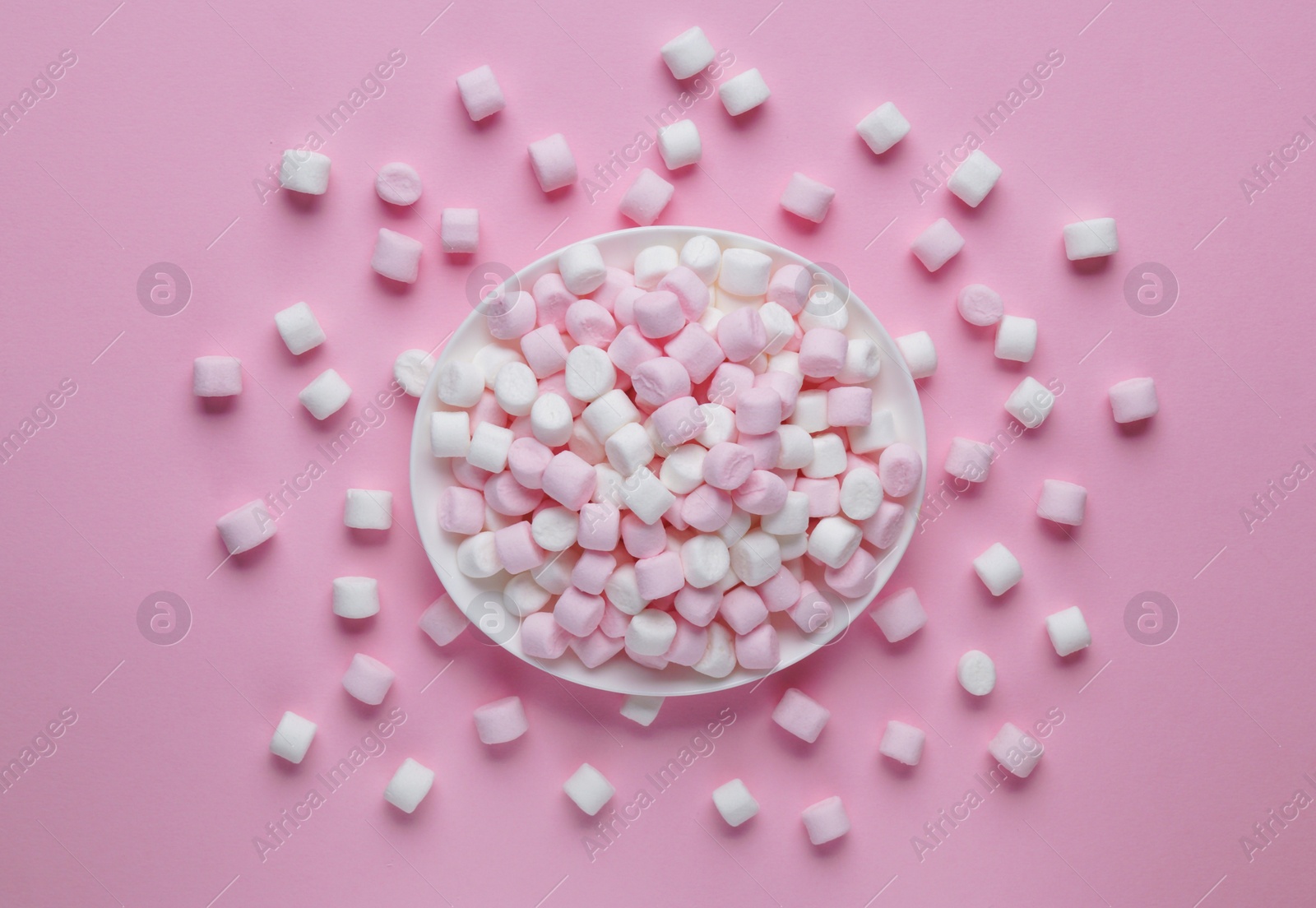 Photo of Plate with delicious marshmallows on pink background, flat lay