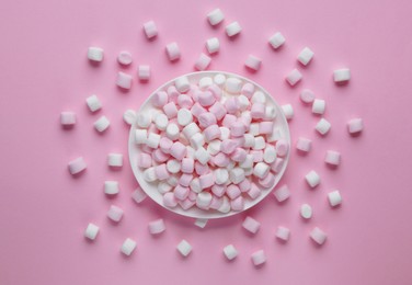 Photo of Plate with delicious marshmallows on pink background, flat lay