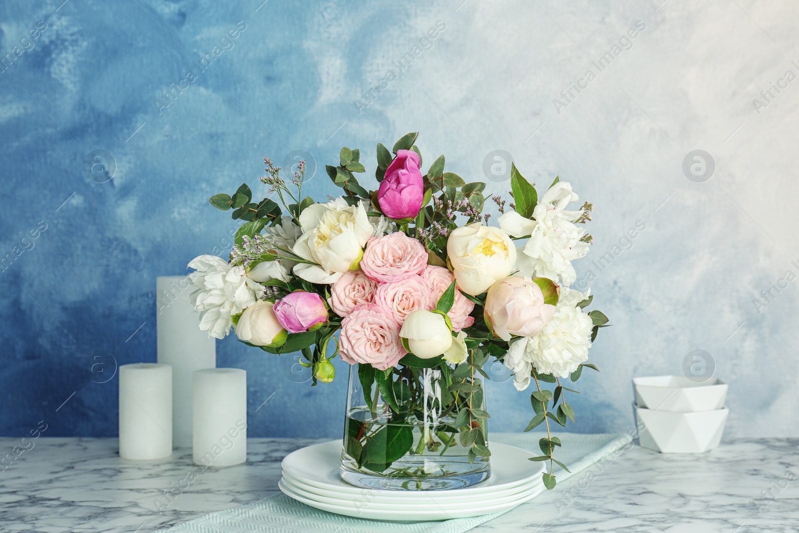 Photo of Vase with bouquet of beautiful flowers on table