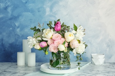 Vase with bouquet of beautiful flowers on table