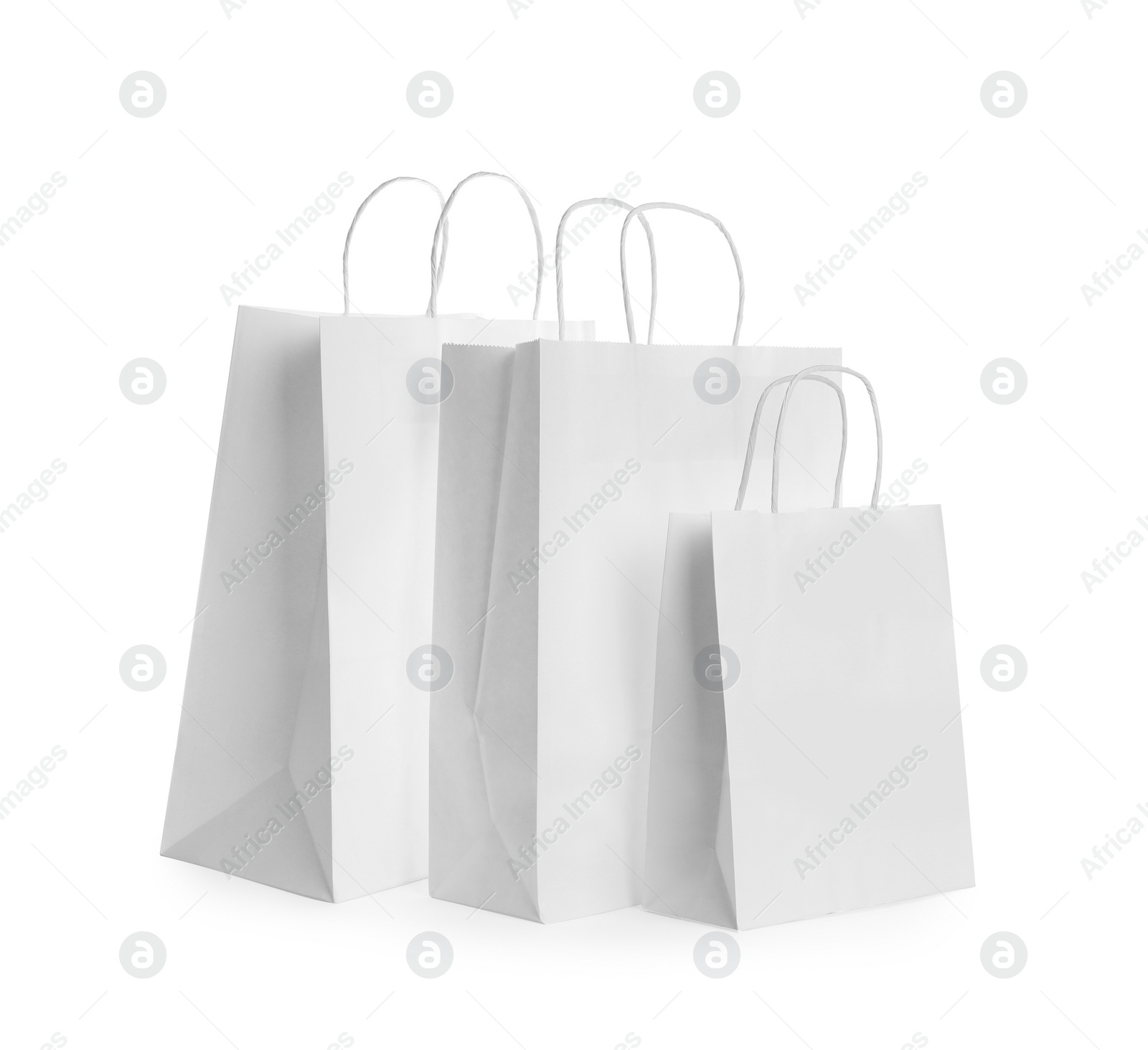 Photo of Blank paper bags on white background. Mockup for design